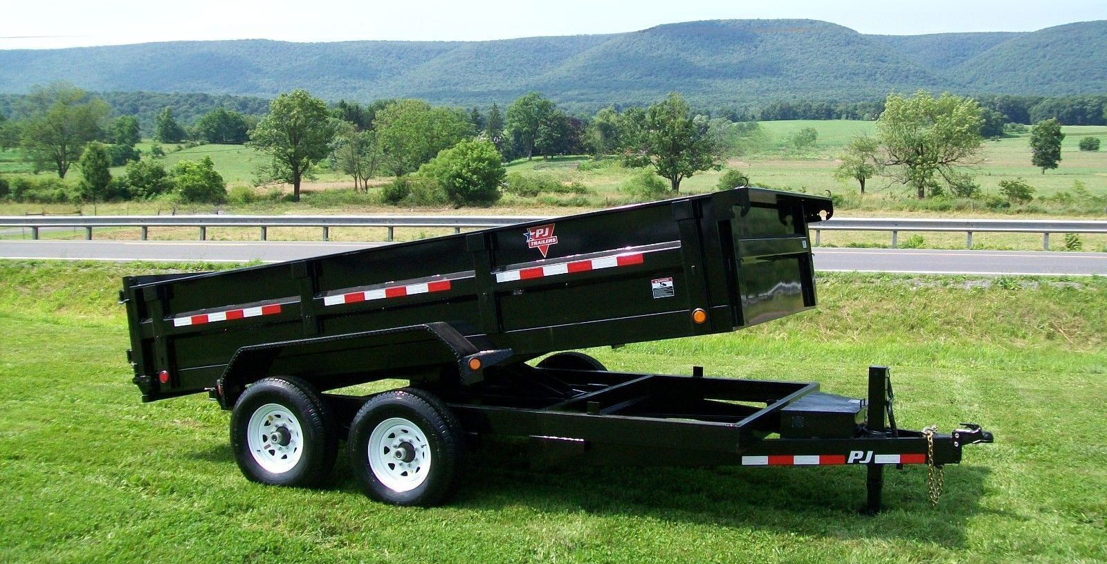 dump-trailer-on-grass-website-header Purge junk removal dump trailer rental on grass